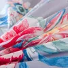 A close-up view of a floral patterned fabric, likely bedding. Produktbild-Vorschau