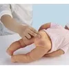 A close-up of a doll's leg and buttocks, with a hand touching the buttocks. Produktbild-Vorschau