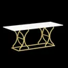 A rectangular dining table with a white marble-look top and gold metal legs, presented against a black background. Anteprima dell’immagine prodotto
