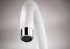 A close-up shot of a white faucet with a chrome aerator. Náhľad obrázku produktu