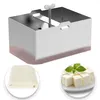 A stainless steel tofu press with a folded cloth and cubed tofu. Produktbild-Vorschau