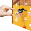 A child's hand is reaching towards a wooden advent calendar with numbered doors. Produktbild-Vorschau