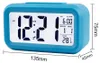 A blue digital alarm clock is shown against a white background with dimensions indicated. Náhled obrázku produktu