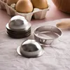 A set of metal cookie cutters and eggs on a pink surface. Produktbild-Vorschau