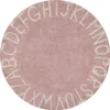 A round rug with letters of the alphabet around the edge.