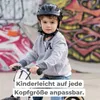 A young boy wearing a black helmet is riding a balance bike in front of a graffiti-covered wall. Náhľad obrázku produktu