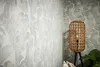 A corner of a room with tropical-themed wallpaper and a rattan floor lamp. Produktbild-Vorschau