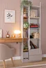 A room with a desk and a tall cabinet. Produktbild-Vorschau