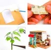 A collage of four images showing different aspects of a miniature DIY model kit, including crafting steps and the finished product. Anteprima dell’immagine prodotto