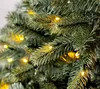 A close-up view of artificial Christmas tree branches with lights. Produktbild-Vorschau