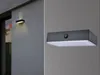 A collage showing two views of a modern outdoor wall light. The left side shows the light mounted on a textured wall, illuminating upwards and downwards. The right side is a close-up of the light, revealing a motion sensor. Produktbild-Vorschau