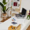 A cash box is open on a desk with money and a calculator. Náhled obrázku produktu