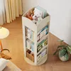 A wooden rotating bookshelf filled with books and a teddy bear, placed in a room with wooden floors and yellow curtains. Produktbild-Vorschau