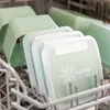 Several green food storage containers are stacked in a dishwasher rack. Náhľad obrázku produktu