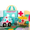 A close-up view of a toy hospital playset with wooden blocks, an ambulance, and a helicopter. Anteprima dell’immagine prodotto