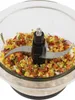 A close-up shot of a food chopper with chopped vegetables inside. Produktbild-Vorschau
