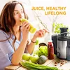 A woman drinks juice next to a juicer and fresh produce. Náhled obrázku produktu