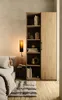 Bedroom interior scene with a bed, shelf unit, and wall lamp. Produktbild-Vorschau
