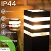 A black outdoor lamp with white stripes, illuminated, with text and icons on the left. Anteprima dell’immagine prodotto