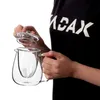 A person is holding a glass teapot with an infuser and lid. Anteprima dell’immagine prodotto