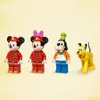Four LEGO figures and a LEGO dog are standing on a light yellow background. Produktbild-Vorschau