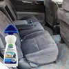 A bottle of cleaning product with a brush attachment is placed in front of car seats. Podgląd zdjęcia produktu