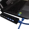 A black USB hub with multiple ports and blue cables connected to a laptop. Produktbild-Vorschau