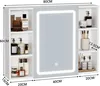 A white bathroom cabinet with a mirrored door and LED lighting, showing various toiletries and cosmetic products on its shelves. Voir les images du produit