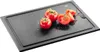 A black cutting board with tomatoes and salt on it. Podgląd zdjęcia produktu