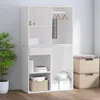 A white storage unit with shelves and a hanging rod, placed against a light gray wall. Voir les images du produit