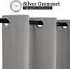 Close-up of grey curtains with silver grommets on a black curtain rod. Produktbild-Vorschau