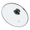 A glass lid with a black handle and a silver rim, shown from a diagonal top-down view on a white background. Náhľad obrázku produktu