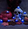 Halloween-themed decoration with skulls, pumpkins, and LED candles. Náhled obrázku produktu