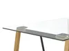A close-up view of a glass-top table with wooden and black metal legs. Podgląd zdjęcia produktu