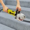 A person is using a yellow and silver wall chaser on concrete stairs. Podgląd zdjęcia produktu