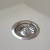 A close-up view of a sink drain with a metal strainer. Podgląd zdjęcia produktu
