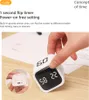 A hand is shown interacting with a white cube timer on a wooden desk with papers in the background. A close-up inset shows another angle of the timer. Produktbild-Vorschau