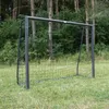 A soccer goal is set up in a grassy area with trees in the background. Produktbild-Vorschau