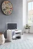 A hallway or entryway scene featuring a shoe bench with storage and a large decorative clock on the wall. Produktbild-Vorschau