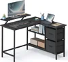 A black L-shaped computer desk with shelves and drawers, featuring a monitor, keyboard, laptop, and decorative items. Produktbild-Vorschau
