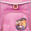 Close-up of a pink backpack with a star pattern and a decorative patch featuring a witch and a phoenix. Voir les images du produit