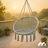 A hanging chair on a patio at sunset. Náhled obrázku produktu