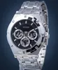 A close-up studio shot of a silver Guess watch with a black dial. Náhled obrázku produktu