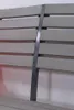 A close-up view of a park bench, showing the slatted seat and backrest with a metal support. Produktbild-Vorschau