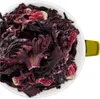 A close-up overhead view of dried hibiscus flowers in a white bowl with a yellow handle. Produktbild-Vorschau