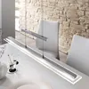 A modern dining room with a long, linear pendant light hanging over a white table. Produktbild-Vorschau