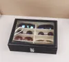 A black sunglasses organizer with a clear lid, filled with sunglasses. Náhled obrázku produktu