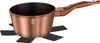 A copper pot with a brown handle sits on a black trivet against a white background. Podgląd zdjęcia produktu