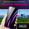 A hand holding a smartphone with a colorful screen display, with a cityscape in the background and text overlays. Produktbild-Vorschau