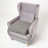 A gray orthopedic seat cushion is placed on a gray armchair. Náhled obrázku produktu